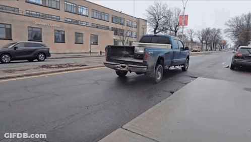 Blue Truck Driving In Front Of Oberlin College GIF