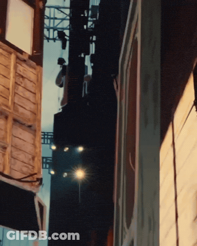 Blurred City Street With Buildings And Street Light GIF