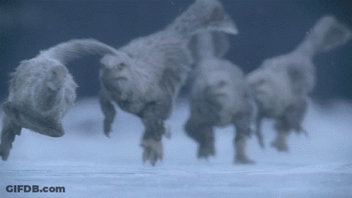 Blurred Dinosaurs Walking In Snow GIF