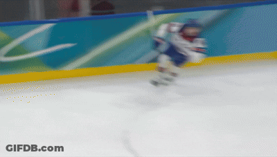 Blurred Hockey Player In Front Of Wall With Letter C GIF