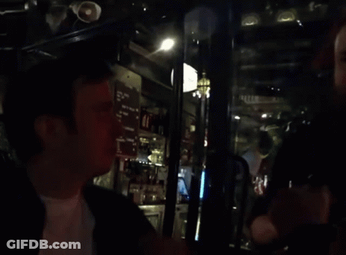 Blurred Man In Bar With Menu On Wall GIF