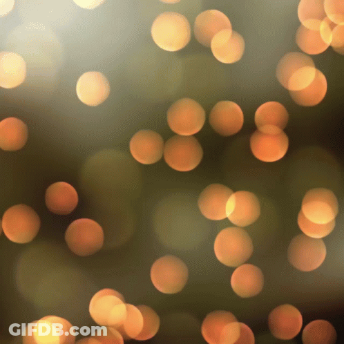Blurred Orange Circles On Dark Brown GIF