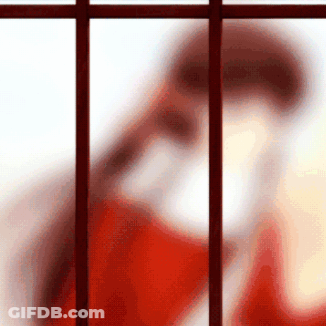 Blurred Person In Red Shirt Behind Bars GIF