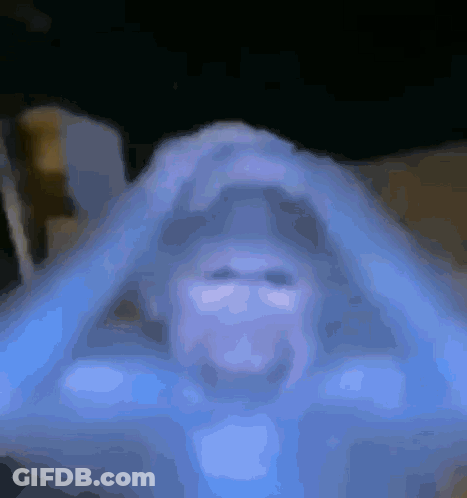 Blurred Person's Face On Blue Background GIF