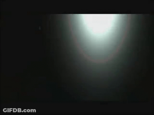 Blurred Person Standing In Front Of Car GIF