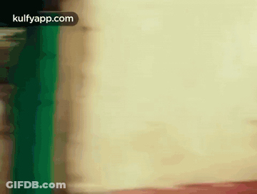 Blurred Person Standing In Front Of White Wall GIF