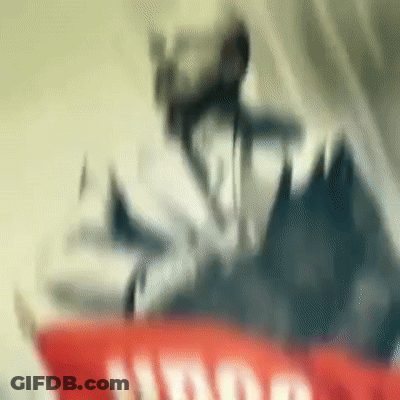 Blurred Person Standing On Red And White Sign GIF