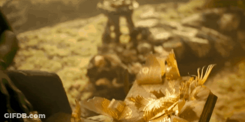 Blurred Pile Of Gold Leaves And Statue GIF