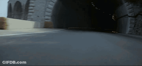 Blurred Race Car Driving Down Street GIF