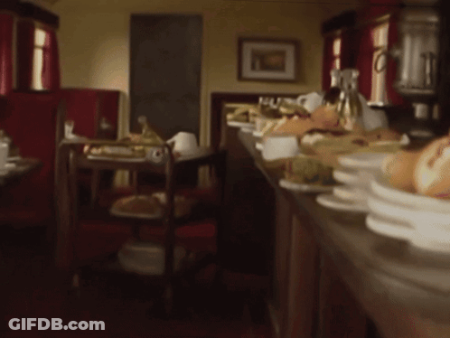 Blurred Restaurant With Plates Of Food On Counter GIF