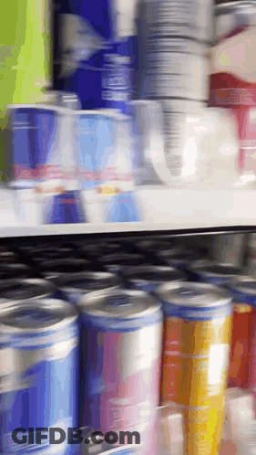 Blurred Store Shelf With Cans And Cups GIF