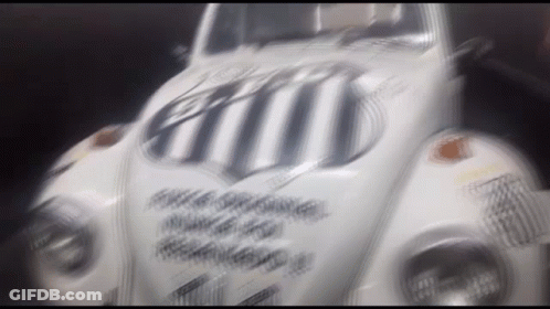 Blurred White Car With Black And White Stripe On Windshield GIF
