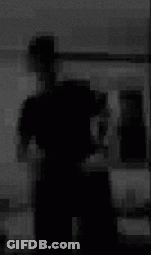 Blurry Black And White Photo Of Person Standing In Room GIF