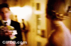 Blurry Bride And Groom Holding Flowers GIF
