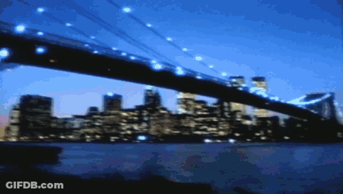 Blurry Bridge Over Water With City Background GIF