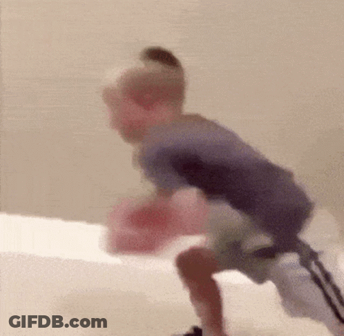 Blurry Child Playing With Pink Object GIF