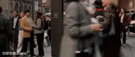 Blurry Crowd Walking Down City Street GIF