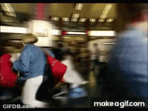 Blurry Crowd Walking In Airport GIF