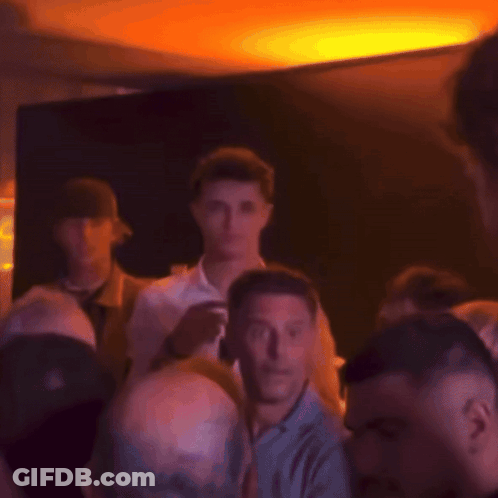 Blurry Crowd With Man In Black Hat GIF