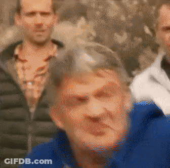 Blurry Group Of People With Woman In Blue Jacket GIF