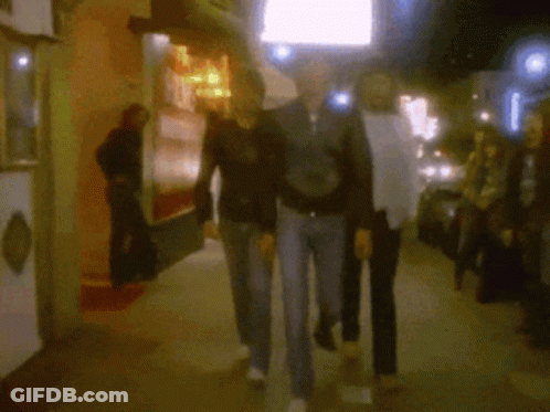Blurry Group Walking Past A's Sign GIF