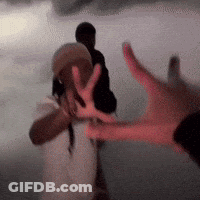 Blurry Hand Reaching Towards Another Person GIF