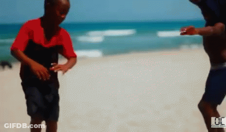 Blurry Man And Boy On Beach With Number 30 GIF