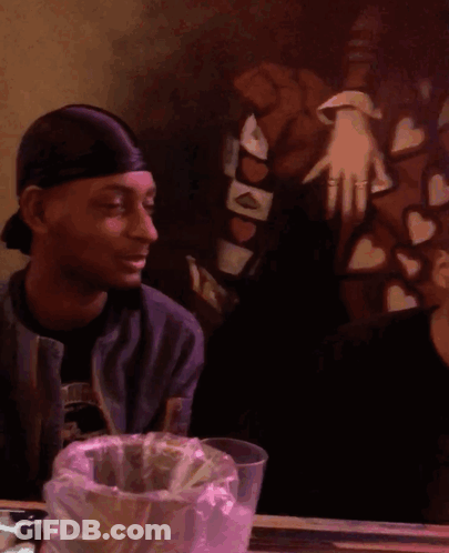 Blurry Man At Table With Bag Of Money GIF