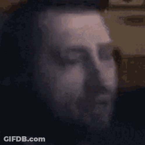Blurry Man Face With Eyes Closed Black Background GIF