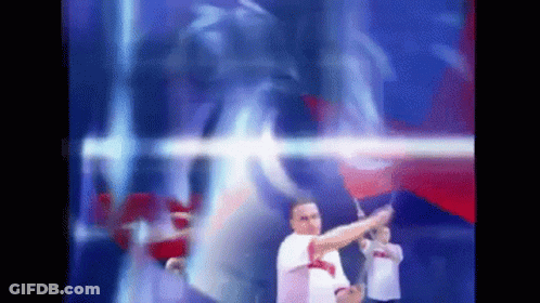 Blurry Man Holding Flag In Front Of Blue And Red Background GIF