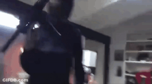 Blurry Man Holding Gun In Room GIF