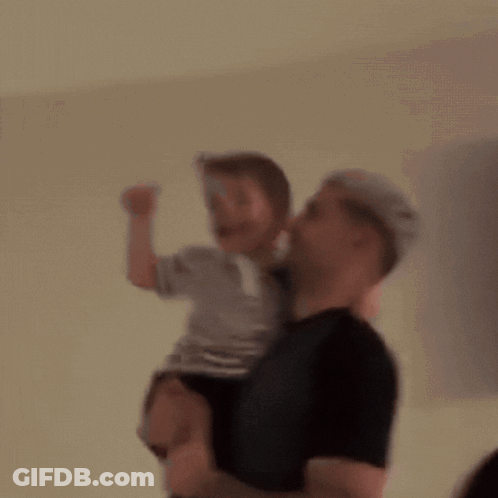 Blurry Man Holding Little Boy GIF