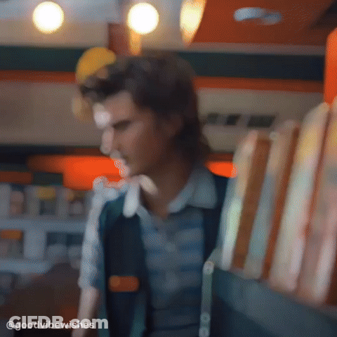 Blurry Man Holding Sandwiches In Restaurant GIF