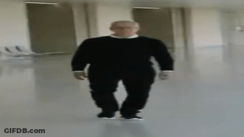 Blurry Man In Black Sweater Walking Down Hallway GIF