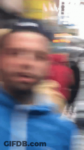 Blurry Man In Blue Jacket GIF
