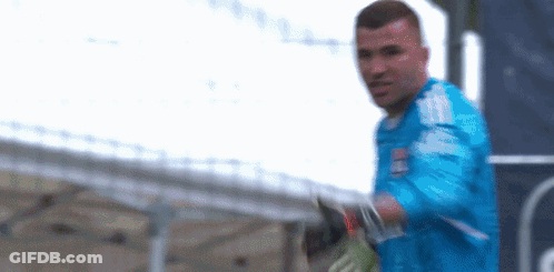 Blurry Man In Blue Shirt And Gloves GIF