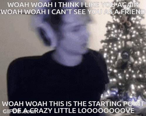 Blurry Man In Front Of Christmas Tree Saying Woah Woah I Think I Like You Again GIF