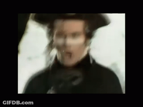 Blurry Man In Hat And Black Coat GIF