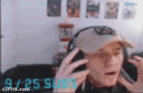 Blurry Man In Headphones And Hat At 9:25 GIF