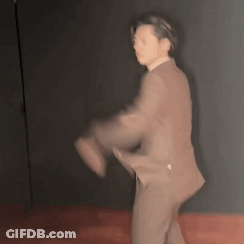 Blurry Man In Suit Dancing On Red Floor GIF