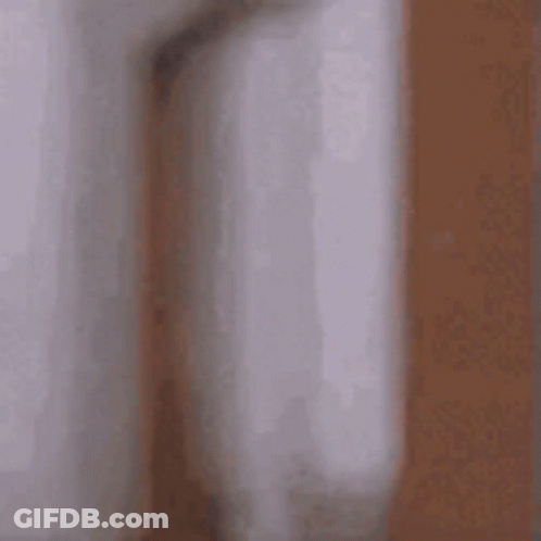 Blurry Man Peeking Behind Wall GIF