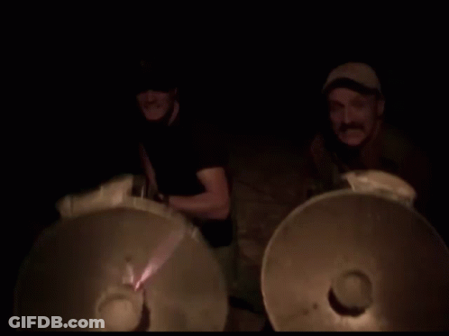 Blurry Man Playing Drums In Dark Room GIF