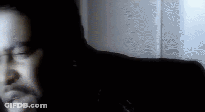 Blurry Man's Face In Dark Room GIF