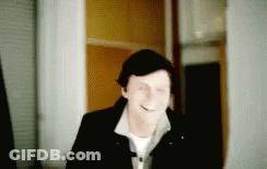 Blurry Man Smiling In Hallway GIF