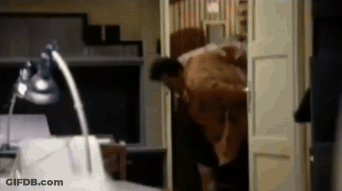 Blurry Man Standing In Doorway With Lamp GIF