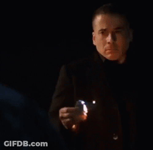 Blurry Man Standing In Front Of Flames GIF