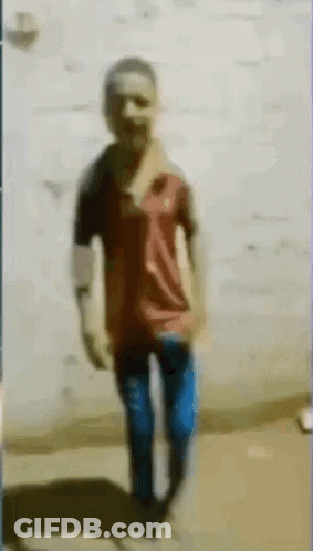 Blurry Man Standing In Front Of Wall GIF