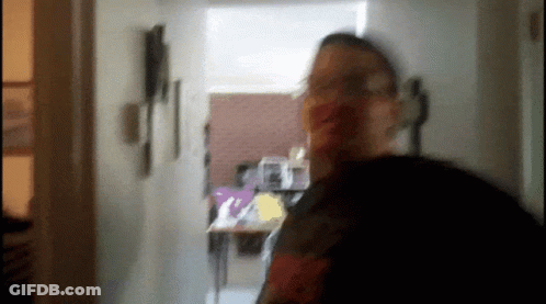 Blurry Man Standing In Hallway GIF