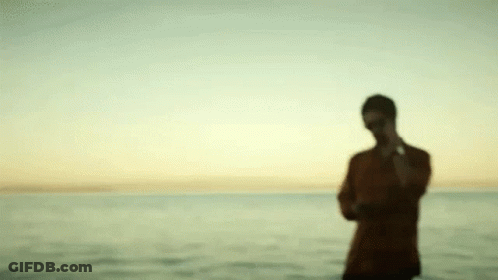 Blurry Man Standing On Beach GIF