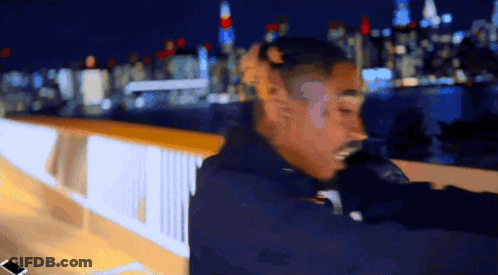 Blurry Man Standing On Bridge At Night GIF